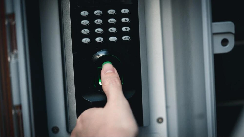 High-Security Biometric Access Control A finger on a biometric fingerprint scanner.