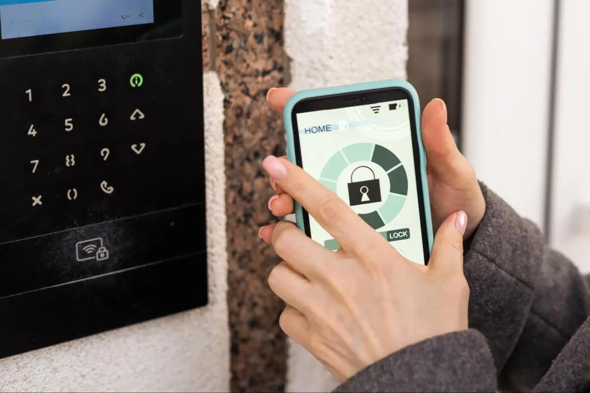 Keypad and Mobile Access Control Hardware Keypad entry system beside a smartphone displaying a digital lock interface for access control