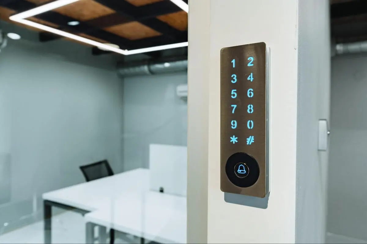 Digital door lock for office access control system installation Electronic digital door lock mounted on a white office wall