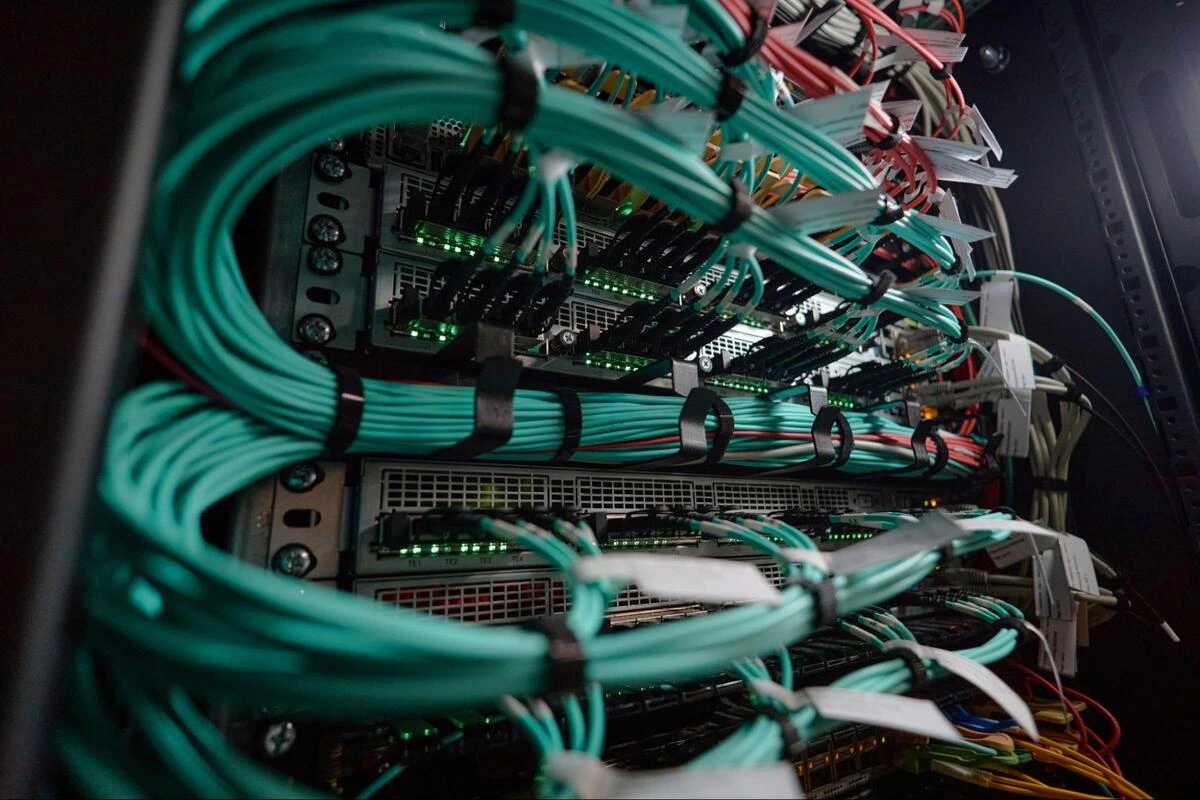 Network Server Rack with Structured Cabling Network server rack with teal-colored patch cables connected to switches