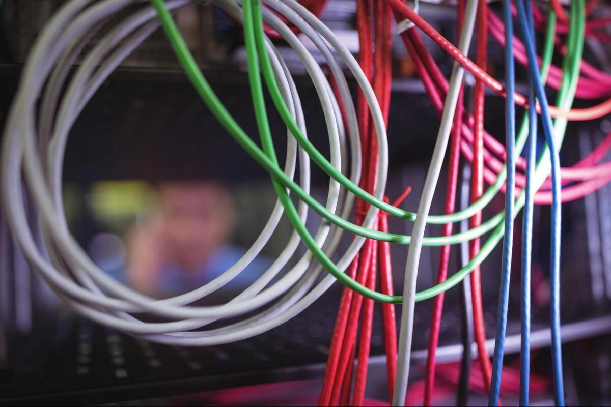 Structured Cabling in a Server Room Coiled cables in various colours bundled in a server room rack